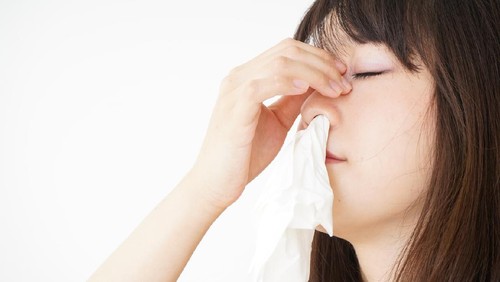 Young woman getting a bloody nose