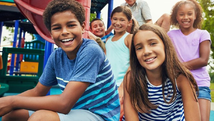 Shot of a group of young friends hanging out together at a playground