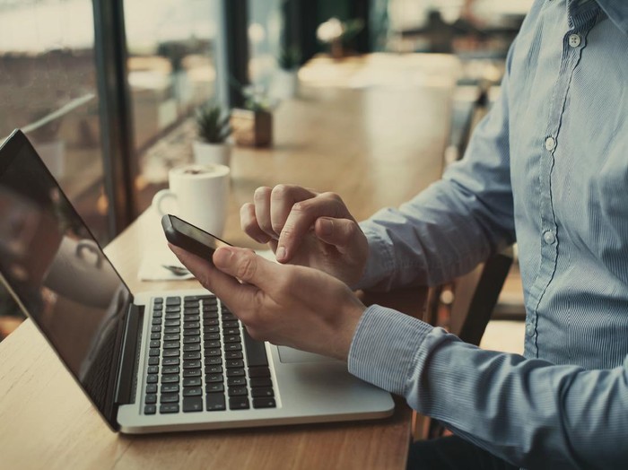 social media, closeup of hands holding smartphone in cafe, banking online, businessman with mobile internet