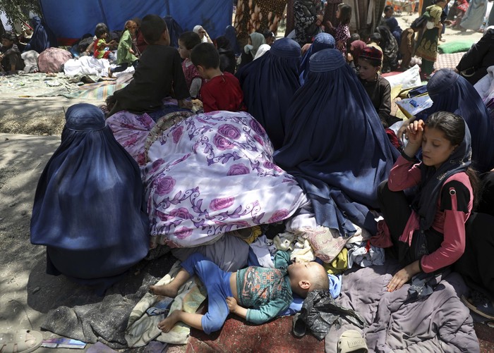 Internally displaced Afghans from northern provinces, who fled their home due to fighting between the Taliban and Afghan security personnel, wait to receive free food in a public park in Kabul, Afghanistan, Tuesday, Aug. 10, 2021. (AP Photo/Rahmat Gul)