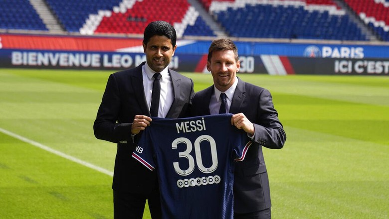 Lionel Messi, right, and PSG president Nasser Al-Al-Khelaifi hold Messis jersey Wednesday, Aug. 11, 2021 at the Parc des Princes stadium in Paris. Lionel Messi said hes been enjoying his time in Paris since the first minute after he signed his Paris Saint-Germain contract on Tuesday night. The 34-year-old Argentina star signed a two-year deal with the option for a third season after leaving Barcelona. (AP Photo/Francois Mori)