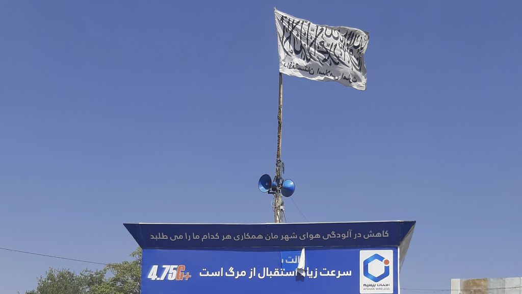 A Taliban flag flies in the main square of Kunduz city after fighting between Taliban and Afghan security forces, in Kunduz, Afghanistan, Sunday, Aug. 8, 2021. Taliban fighters Sunday took control of much of the capital of northern Afghanistan's Kunduz province, including the governor's office and police headquarters, a provincial council member said. (AP Photo/Abdullah Sahil)