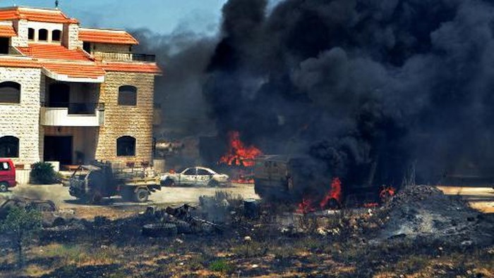 Vehicles burn outside the reported home of the lot owner, where the exploded fuel tank was placed, in the village of Tlel in Lebanons northern region of Akkar on August 15, 2021. - At least 20 people were killed and nearly 80 others injured when a fuel tank exploded in Lebanons northern region of Akkar, the Red Cross and state media said. The official National News Agency said the explosion took place following scuffles between 
