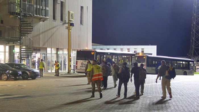 In the photo provided by the Ministry of Defence, passengers from the first flight carrying evacuated personnel of British Embassy staff and British Nationals, after arriving at RAF Brize Norton, England, early Monday Aug. 16, 2021. Taliban forces have toppled the Western-backed Afghanistan government, as international nations scramble to evacuate diplomats, employees and their families from Kabul. (Sharron Flyod/Ministry of Defence via AP)