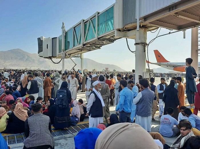 Afghans crowd at the tarmac of the Kabul airport on August 16, 2021, to flee the country as the Taliban were in control of Afghanistan after President Ashraf Ghani fled the country and conceded the insurgents had won the 20-year war. (Photo by - / AFP)