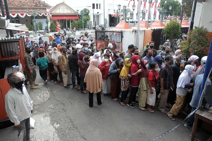 Warga Antri Tanpa Jaga Jarak Demi 10 Kg Beras di Yogyakarta Pembagian BST berupa beras 10 kilogram dilakukan di Kantor Pos Besar, Yogyakarta, Selasa (17/8/2021). Warga tampak mengantre dengan mengabaikan protokol kesehatan.