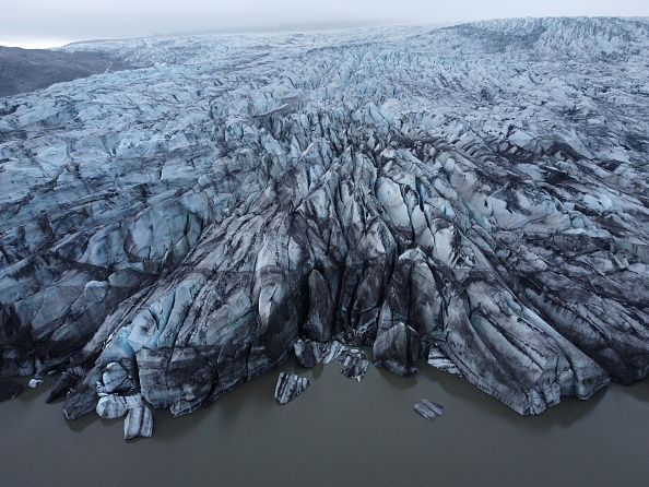 HOFN, HORNAFJORDUR, ICELAND - AUGUST 17: In this aerial view Hoffellsjokull glacier lies behind moraines and an iceberg-filled lagoon the glacier once covered on August 17, 2021 near Hofn, Iceland. Iceland is feeling a strong impact from global warming. Since the 1990s 90% of Iceland's glaciers have been retreating and projections for the future show a continued and strong reduction in size of its five ice caps. Flaajokull is one of dozens of glacier tongues that descend from Vatnajokull, Iceland's biggest ice cap.  (Photo by Sean Gallup/Getty Images)