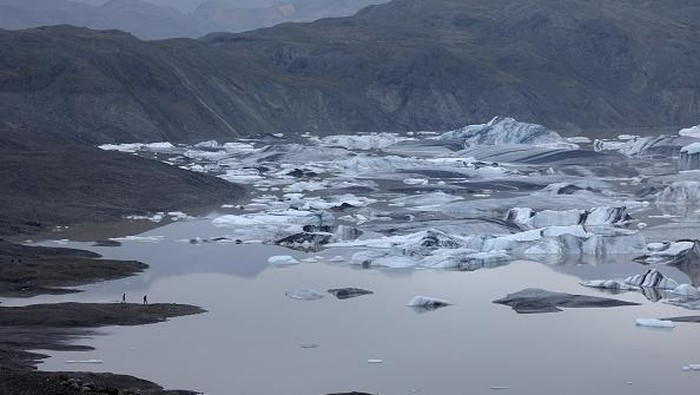 HOFN, HORNAFJORDUR, ICELAND - AUGUST 17: In this aerial view Hoffellsjokull glacier lies behind moraines and an iceberg-filled lagoon the glacier once covered on August 17, 2021 near Hofn, Iceland. Iceland is feeling a strong impact from global warming. Since the 1990s 90% of Iceland's glaciers have been retreating and projections for the future show a continued and strong reduction in size of its five ice caps. Flaajokull is one of dozens of glacier tongues that descend from Vatnajokull, Iceland's biggest ice cap.  (Photo by Sean Gallup/Getty Images)
