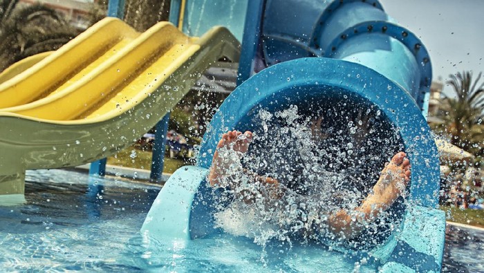 Little girl in water park. Actually little feet in waterpark.