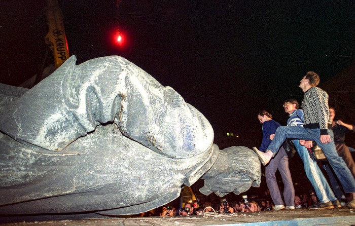 Russia Chronicling Soviet Coup FILE - In this Friday, Aug. 23, 1991 file photo, people kick the head of the statue of Felix Dzerzhinsky, the founder of the Soviet secret police, in front of the KGB main headquarters on the Lubyanka Square in Moscow, Russia. The statue was pulled down after the defeat of the August 1991 hardline coup. I was out on the streets, shooting exultant crowds across the city and managed to catch the moment when demonstrators pulled down the statue of Felix Dzerzhinsky, the founder of the Soviet secret police, in front of the KGB main headquarters on the Lubyanka Square - a watershed moment that symbolized the collapse of the repressive Soviet system.(AP Photo/Alexander Zemlianichenko, File)