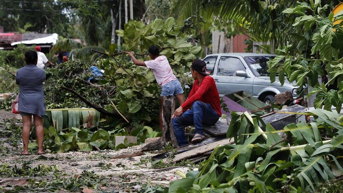 Agustin Mariche begins to clear debris after a tree fell on his room, brought down by the winds of Hurricane Grace in Tulum, Quintana Roo state, Mexico, Thursday, Aug. 19, 2021. The Category 1 storm made landfall at 4:45 a.m., just south of the ancient Mayan temples of Tulum, pelting the Caribbean coast with heavy rain and pushing a dangerous storm surge. (AP Photo/Marco Ugarte)