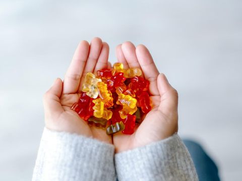 Top view image of a woman holding colorful Jelly gum in hands