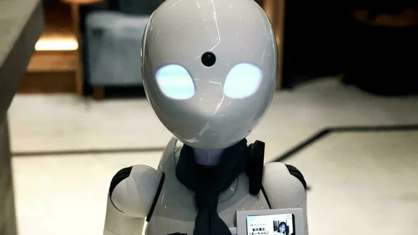 Manusia yang mengoperasikan si robot tidak ada di kafe, dia berada di rumahnya. (Behrouz Mehri/AFP)