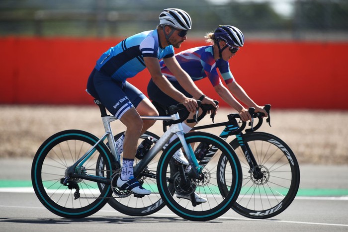 1262610003 NORTHAMPTON, ENGLAND - JULY 30: Valtteri Bottas of Finland and Mercedes GP and girlfriend and road cyclist Tiffany Cromwell cycle on track during previews ahead of the F1 Grand Prix of Great Britain at Silverstone on July 30, 2020 in Northampton, England. (Photo by Bryn Lennon/Getty Images)
