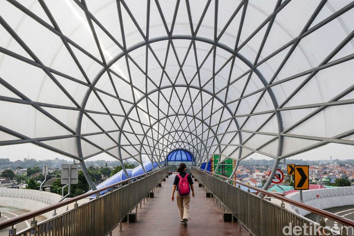 sejumlah warga tampak menyeberang melewati Jembatan Penyebrangan Orang (JPO) Lenteng Agung, Jakarta Selatan, Sabtu (21/8/2021).