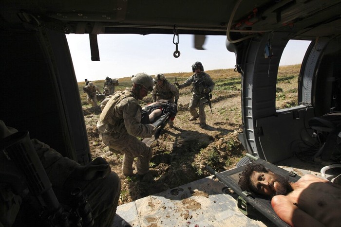 397732 21: (NEWSWEEK AND US NEWS AND WORLD REPORT OUT UNTIL DECEMBER 10, 2001) American soldiers hide behind a barricade during an explosion, prior to fighting with Taliban forces November 26, 2001 at the fortress near Mazar-e-Sharif, northern Afghanistan. The fighting came after several hundred prisoners, mostly foreigners fighting for the Taliban, captured part of fortress. The fortress was also the headquarters of alliance commander Gen. Rashid Dostum. (Photo by Oleg Nikishin/Getty Images)