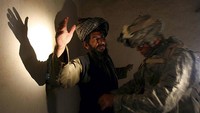 Tentara AS memeriksa pria Afghanistan di rumahnya, di sebuah desa di Provinsi Zabul (2/4/2007).  (AP Photo/Rafiq Maqbool)