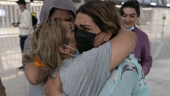 Families evacuated from Kabul, Afghanistan, are loaded into a buses after they arrived at Washington Dulles International Airport, in Chantilly, Va., on Saturday, Aug. 21, 2021. (AP Photo/Jose Luis Magana)