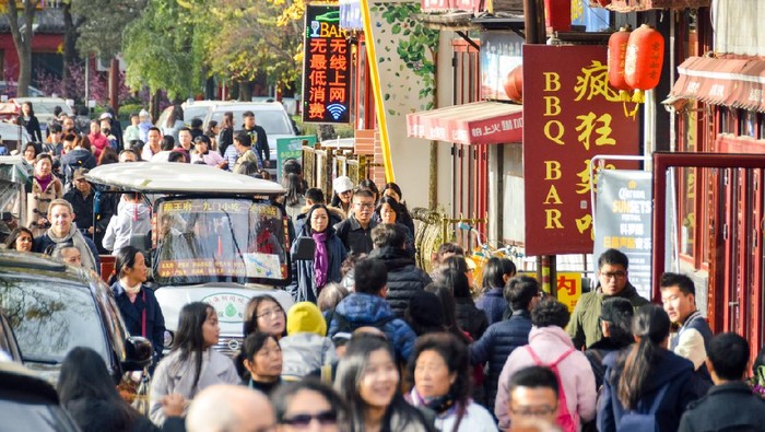 Beijing, China - November 19, 2016: Typical crowded hutong street in Beijing, China. Photo taken during the day and contains many people.