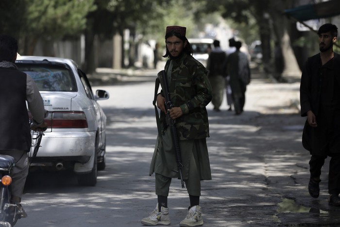 A Taliban fighter stands guard at a checkpoint in the Wazir Akbar Khan neighborhood in the city of Kabul, Afghanistan, Sunday, Aug. 22, 2021. A panicked crush of people trying to enter Kabuls international airport killed several Afghan civilians in the crowds, the British military said Sunday, showing the danger still posed to those trying to flee the Talibans takeover of the country. (AP Photo/Rahmat Gul)
