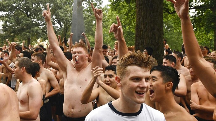 As the Class of 2023 begins the Herndon Monument Climb, the first challenge is to remove the gobs of vegetable shortening slathered on the 21-foot monument by the seniors, known as Firsties, Sunday, Aug. 22, 2021, at the U.S. Naval Academy in Annapolis, Md. The Herndon Monument Climb traditionally takes place at the end of the first year, but was canceled in 2020 due to the pandemic. (Amy Davis/The Baltimore Sun via AP)
)