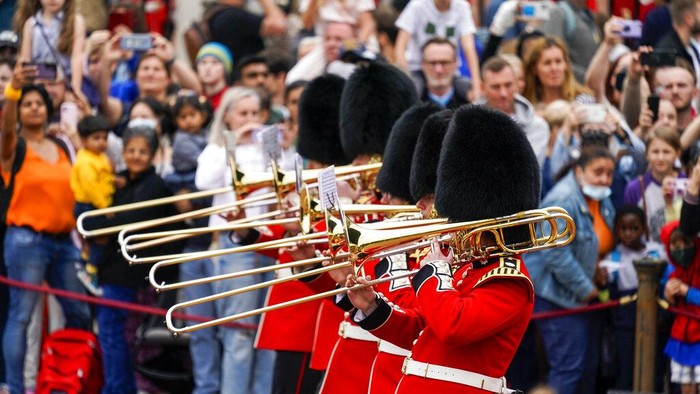 Members of the public watch the Changing of the Guard ceremony at Buckingham Palace, London, Monday August 23, 2021, which is taking place for the first time since the start of the coronavirus pandemic. (AP Photo/Alberto Pezzali)