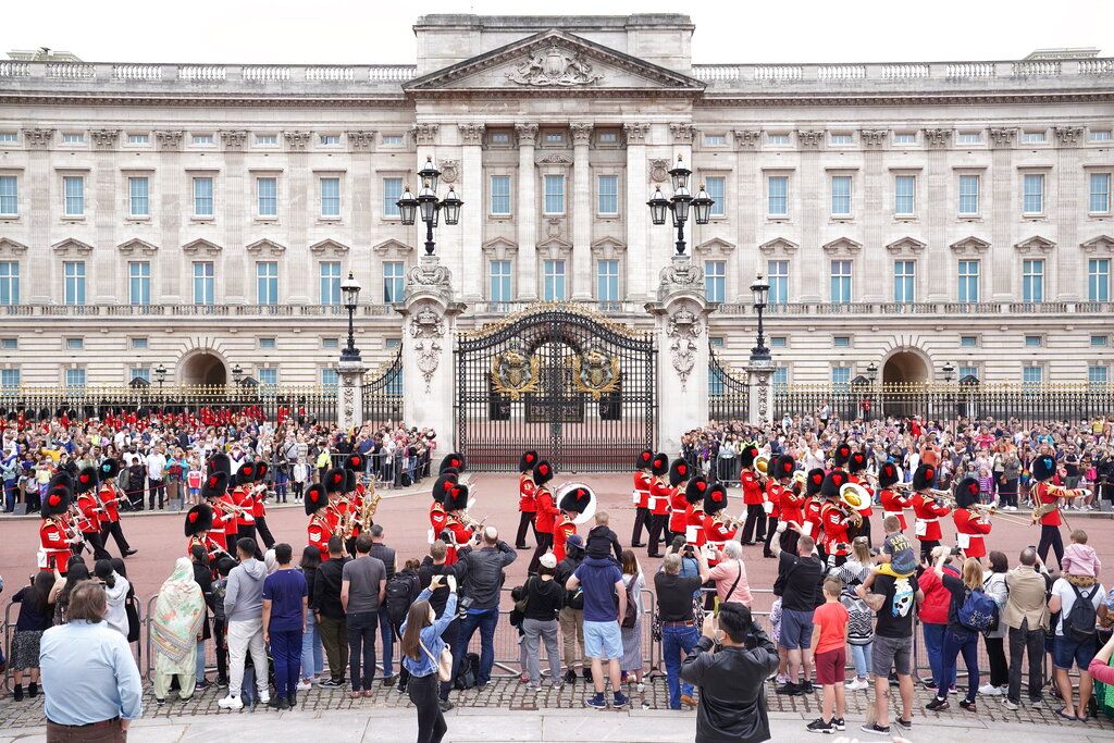 Members of the public watch the Changing of the Guard ceremony at Buckingham Palace, London, Monday August 23, 2021, which is taking place for the first time since the start of the coronavirus pandemic. (AP Photo/Alberto Pezzali)