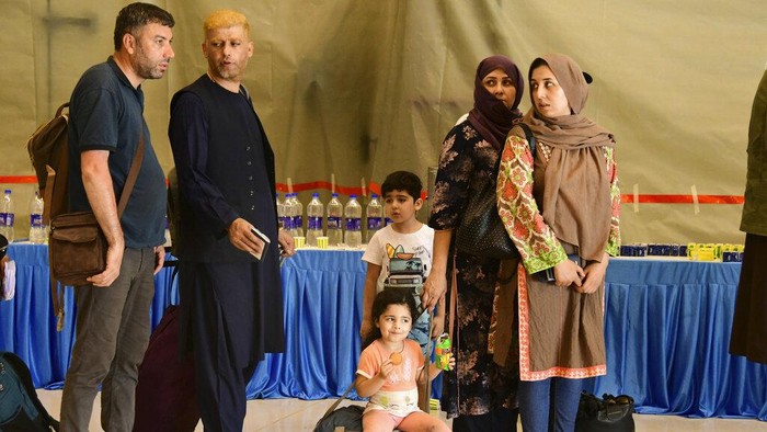 People evacuated from Kabul arrive at Hindon Air force base near New Delhi, India. Sunday, Aug. 22, 2021. A special military flight carrying 168 people, which include 107 Indian nationals and 61 others, landed at Hindon Air force base near New Delhi, according to the External Affairs Ministry spokesman. (AP Photo)