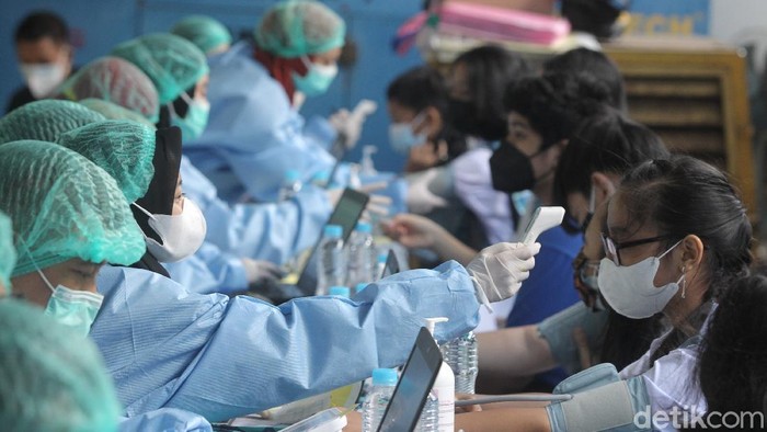 Vaksinasi Pelajar Kota Jogya Dikebut Menuju Sekolah Tatap Muka Siswa/i menerima vaksin jenis sinovac saat pelaksanaan vaksinasi massal untuk pelajar di kantor PDAM Tirta Marta, Yogyakarta, Selasa (24/8/2021). Siswa yang sudah divaksin menerima gelang vaksin.