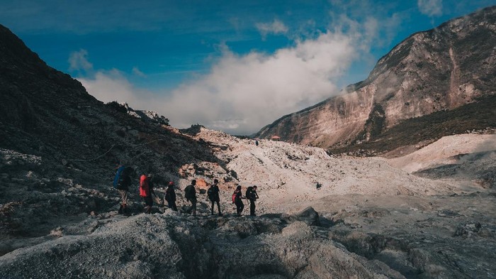 Garut - Indonesia - July 9, 2018 : Group of Hikers Walking in Papandayan Mountain Garut Indonesia