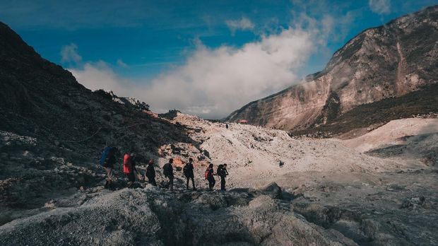 Garut - Indonesia - July 9, 2018 : Group of Hikers Walking in Papandayan Mountain Garut Indonesia