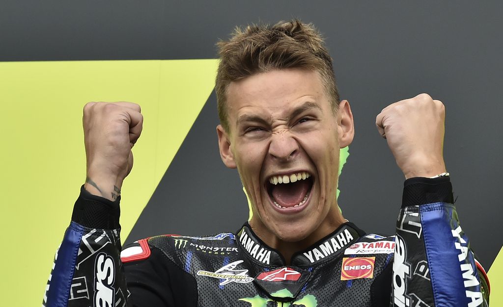 MotoGP race winner France's rider Fabio Quartararo of the Monster Energy Yamaha MotoGP celebrates on the podium after the MotoGP race at the British Motorcycle Grand Prix at the Silverstone racetrack, in Silverstone, England, Sunday, Aug. 29, 2021. (AP Photo/Rui Vieira)