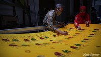 Anggota koperasi mewarnai batik motif ondel ondel di Koperasi Konsumen Batik Betawi di Perkampungan Industri Kecil (PIK) Penggilingan, Cakung, Jakarta Timur, Senin, (30/8/2021).
