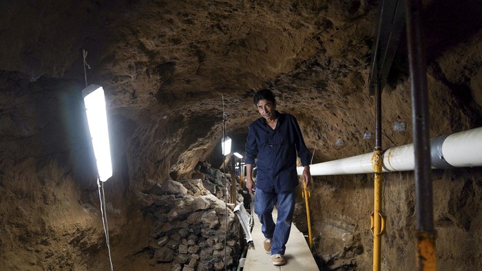 Archaeologist Sergio Gomez walks inside a 2,000-year-old tunnel built under the ornate Feathered Serpent Pyramid, which archaeologist Sergio Gomez believes recreated the underworld and was used to initiate new rulers among other religious rituals, in the ruins of Teotihuacan, in San Juan Teotihuacan, Mexico August 12, 2021. Picture taken August 12, 2021. REUTERS/Toya Sarno Jordan