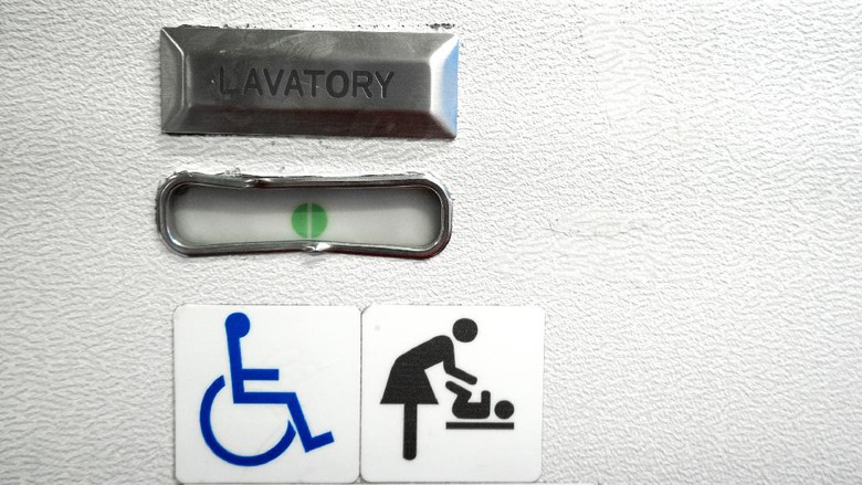 lavatory pesawat A sign in the toilet of an airplane, meaning that the toilet is equipped for disabled people. And it has a changing table.