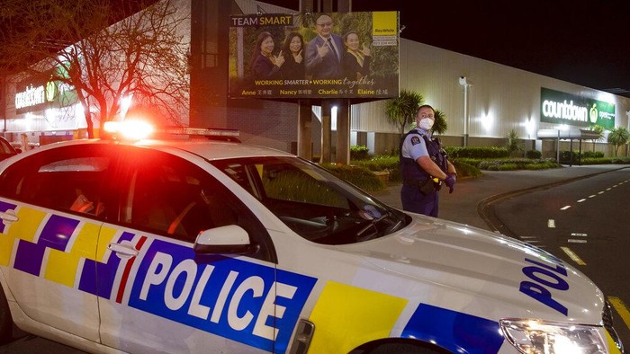 Police stand outside the site of a knife attack at a supermarket in Auckland, New Zealand, Friday, Sept. 3, 2021. New Zealand authorities say they shot and killed a violent extremist after he entered the supermarket and stabbed and injured six shoppers. New Zealand Prime Minister Jacinda Ardern described Fridays incident as a terror attack. (AP Photo/Brett Phibbs)