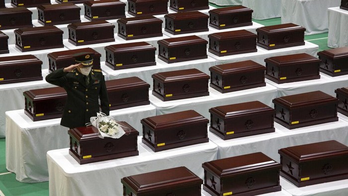 A Chinese honor guard with caskets containing the remains of Chinese soldiers moves into a cargo airplane during the handing over ceremony at the Incheon International Airport in Incheon, South Korea, Thursday, Sept. 2, 2021. The remains of 109 Chinese soldiers killed during the 1950-53 Korean War were transferred from the temporary columbarium in South Korea to the airport to return home for permanent burial. (AP Photo/Ahn Young-joon, Pool)