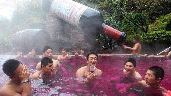 HAKONE, JAPAN - NOVEMBER 19:  Visitors taste Beaujolais Nouveau at the open air wine spa at the Hakone Kowakien Yunessun on November 19 in Hakone, Kanagawa, Japan. The spa complex launched an open air wine spa four years ago and the event takes place every year.  (Photo by Junko Kimura/Getty Images)