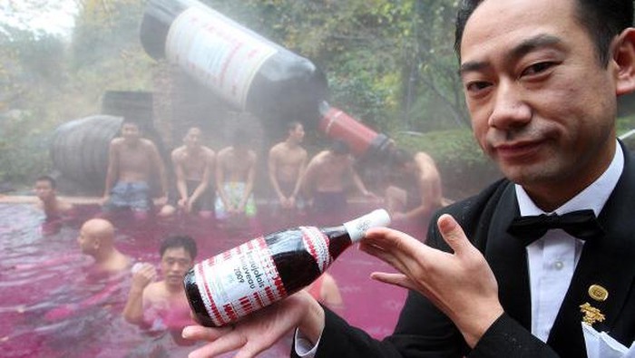 HAKONE, JAPAN - NOVEMBER 19:  Visitors taste Beaujolais Nouveau at the open air wine spa at the Hakone Kowakien Yunessun on November 19 in Hakone, Kanagawa, Japan. The spa complex launched an open air wine spa four years ago and the event takes place every year.  (Photo by Junko Kimura/Getty Images)