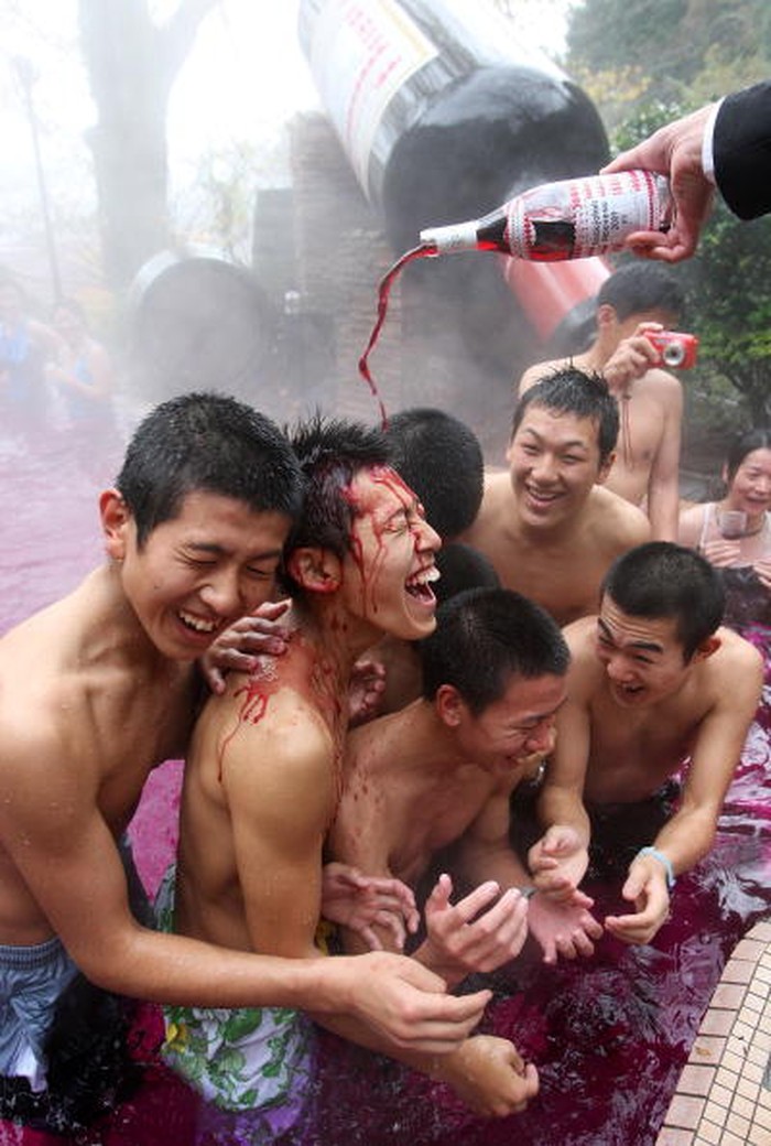 HAKONE, JAPAN - NOVEMBER 19:  Visitors taste Beaujolais Nouveau at the open air wine spa at the Hakone Kowakien Yunessun on November 19 in Hakone, Kanagawa, Japan. The spa complex launched an open air wine spa four years ago and the event takes place every year.  (Photo by Junko Kimura/Getty Images)