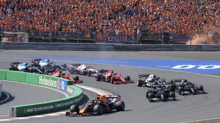 Red Bull driver Max Verstappen of the Netherlands leads at the start and followed by Mercedes driver Lewis Hamilton of Britain and Mercedes driver Valtteri Bottas of Finland during the Formula One Dutch Grand Prix, at the Zandvoort racetrack, Netherlands, Sunday, Sept. 5, 2021. (AP Photo/Peter Dejong)