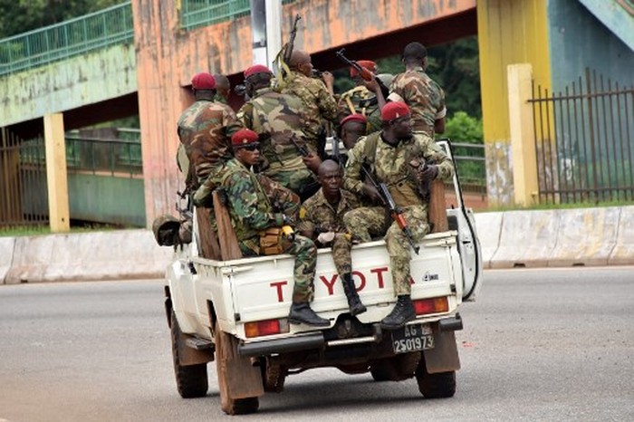 Members of the Armed Forces of Guinea drive through the central neighbourhood of Kaloum in Conakry on September 5, 2021 after sustainable gunfire was heard. - Gunfire was heard in Conkary in the morning and troops were seen on the streets, witnesses told AFP. There was no immediate explanation for the incidents in Conakrys Kaloum peninsula, where the presidency, various institutions and offices are located. (Photo by CELLOU BINANI / AFP)