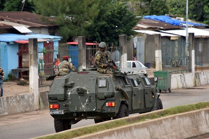Members of the Armed Forces of Guinea drive through the central neighbourhood of Kaloum in Conakry on September 5, 2021 after sustainable gunfire was heard. - Gunfire was heard in Conkary in the morning and troops were seen on the streets, witnesses told AFP. There was no immediate explanation for the incidents in Conakrys Kaloum peninsula, where the presidency, various institutions and offices are located. (Photo by CELLOU BINANI / AFP)