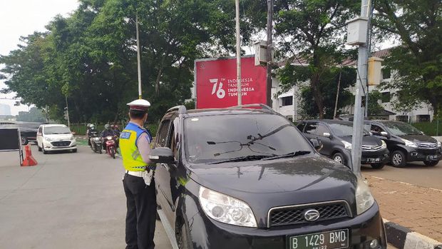 Polisi saat memberi tilang ke pemobil langgar ganjil genap di Jl Sudirman, Jakarta (Adhyasta-detikcom)