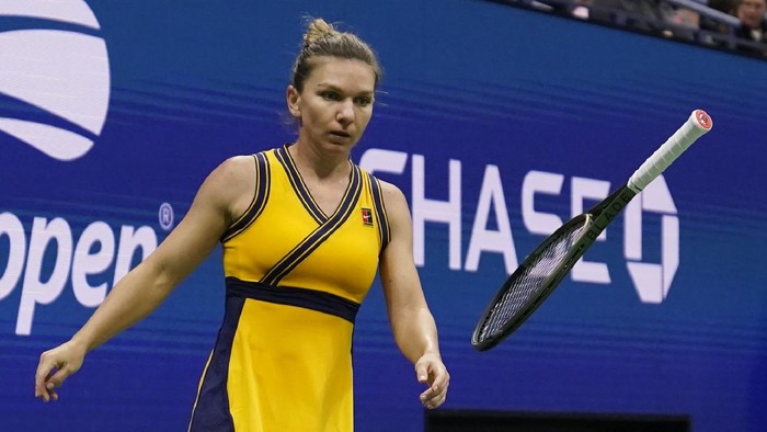 Simona Halep, of Romania, tosses her racket as she plays Elina Svitolina, of Ukraine, during the fourth round of the US Open tennis championships, Sunday, Sept. 5, 2021, in New York. (AP Photo/Seth Wenig)