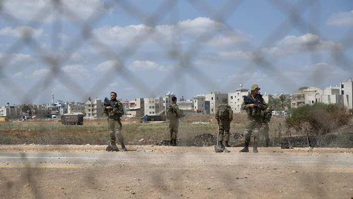 Israeli soldiers stand guard near a damaged section of the Israeli separation fence, that is used by Palestinian laborers to cross into Israel, in the West Bank village of Jalameh, near Jenin, Monday, Sept. 6, 2021. Israel launched a massive manhunt in the countrys north and the occupied West Bank early Monday after six Palestinian prisoners tunneled out of their cell and escaped overnight from a high-security facility in an extremely rare breakout. (AP Photo/Nasser Nasser)