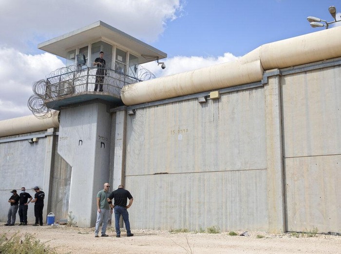 Police officers and prison guards inspect the scene of a prison escape outside the Gilboa prison in Northern Israel, Monday, Sept. 6, 2021. Israeli forces on Monday launched a massive manhunt in northern Israel and the occupied West Bank after six Palestinian prisoners escaped overnight from a high-security facility in an extremely rare breakout. (AP Photo/Sebastian Scheiner)