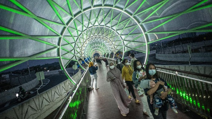 JPO LENTENG AGUNG UNTUK PENGGERAK EKONOMI Warga berjalan di Jembatan Penyeberangan Orang (JPO) Lenteng Agung, Jakarta, Minggu (5/9/2021). Gubernur DKI Jakarta Anies Baswedan berharap dengan selesainya pembangunan JPO Lintas Atas Lenteng Agung yang berada di atas putaran tapal kuda Lenteng Agung - Tanjung Barat dapat menggerakkan ekonomi warga setempat. ANTARA FOTO/Aprillio Akbar/rwa.