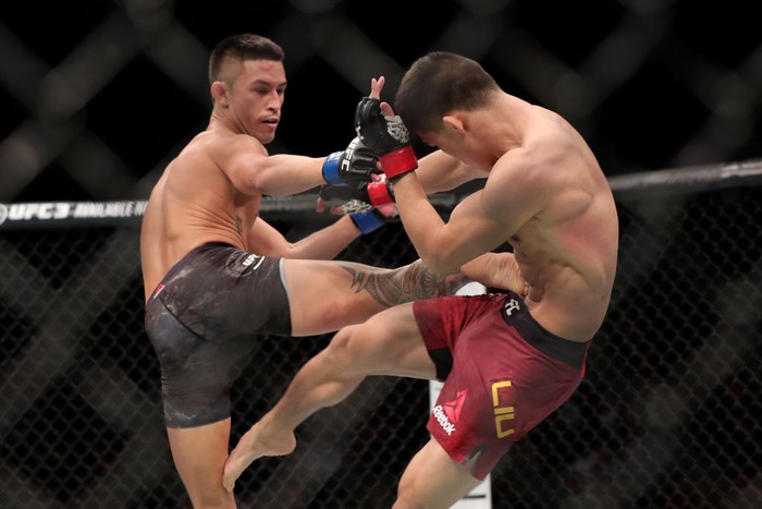BEIJING, CHINA - NOVEMBER 24:  (L-R) Martin Day kicks Liu Pingyuan of China in their bantamweight bout during the UFC Fight Night event at Cadillac Arena on November 24, 2018 in Beijing, China.  (Photo by Emmanuel Wong/Getty Images)