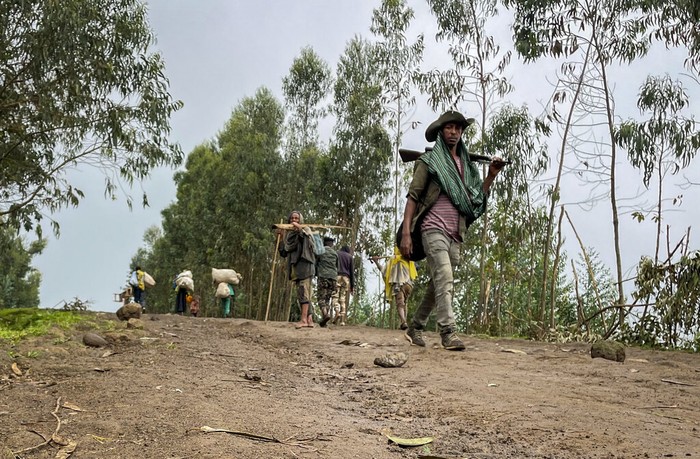 The dead bodies of unidentified people wearing military uniforms lie on the ground near the village of Chenna Teklehaymanot, in the Amhara region of northern Ethiopia Thursday, Sept. 9, 2021. At the scene of one of the deadliest battles of Ethiopia's 10-month Tigray conflict, witness accounts reflected the blurring line between combatant and civilian after the federal government urged all capable citizens to stop Tigray forces 